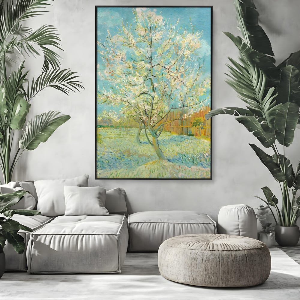 Tablou canvas cu pictura cu un copac inflorit primavara, in rama de aluminiu negru, pe perete intr-un living